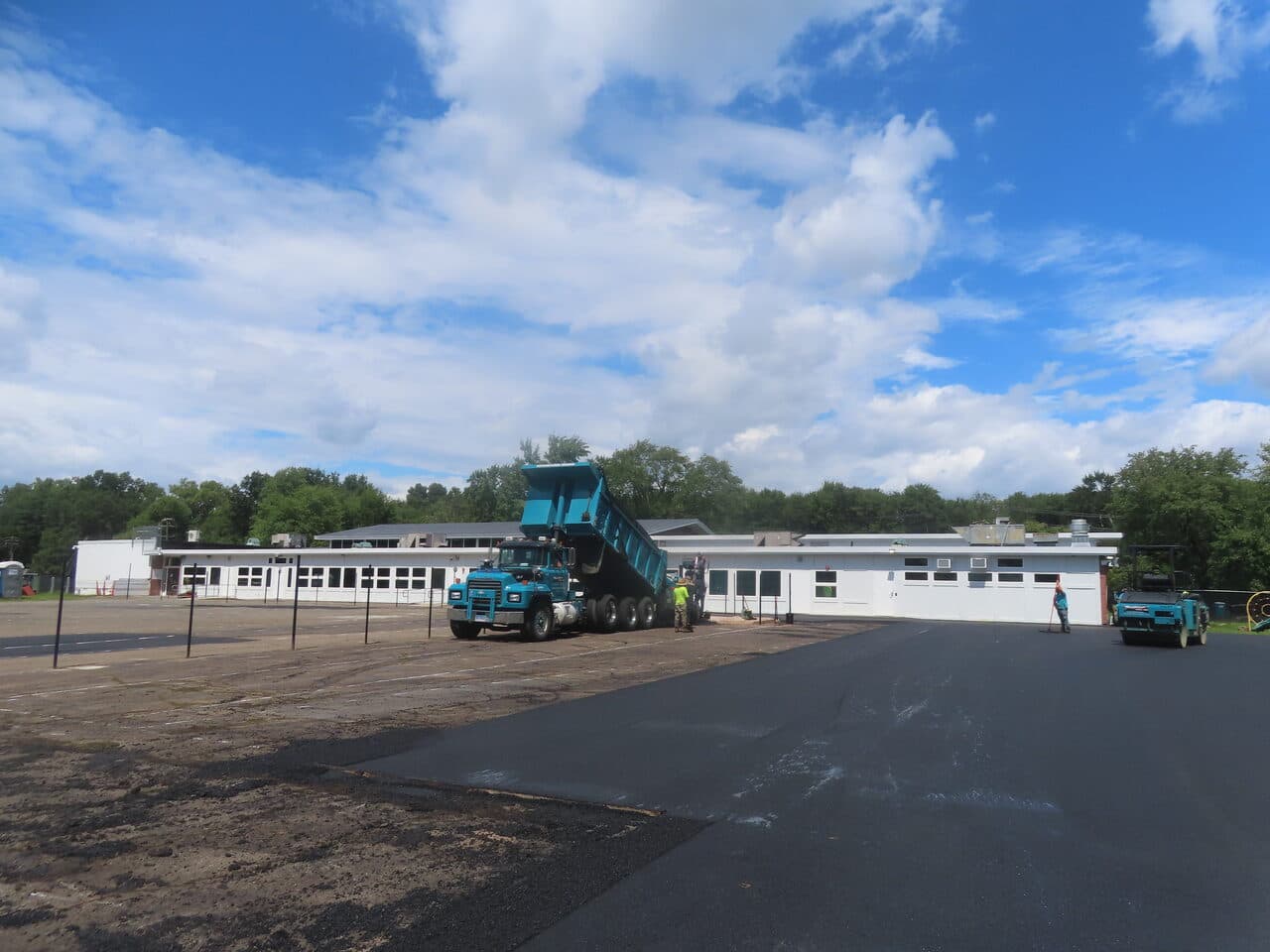 Commercial Parking Lot Paving project in Bloomfield, CT — dump truck unloading on new lot