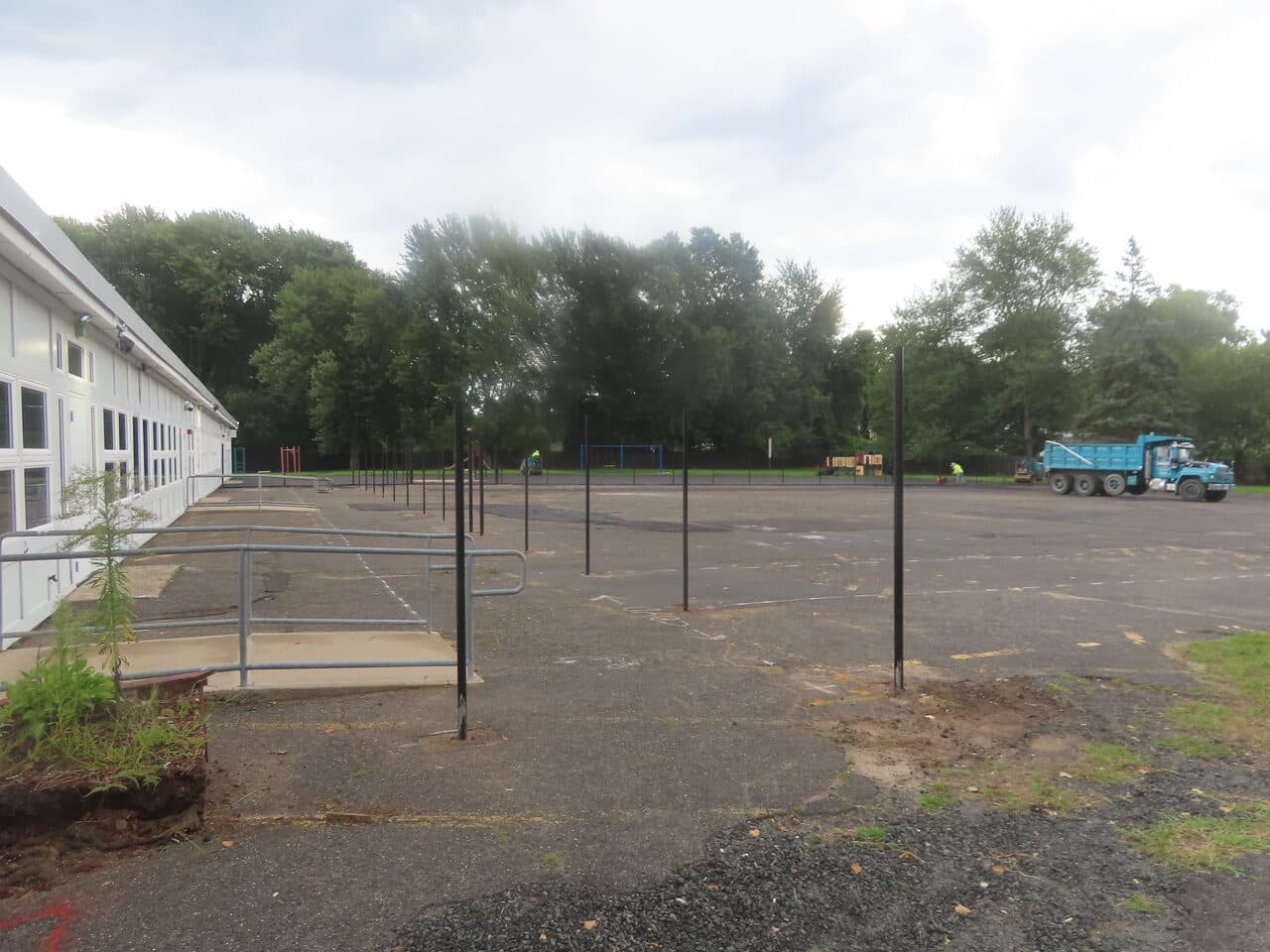 Before — Commercial Parking Lot Paving in Bloomfield, CT (bare lot before paving with fence posts)