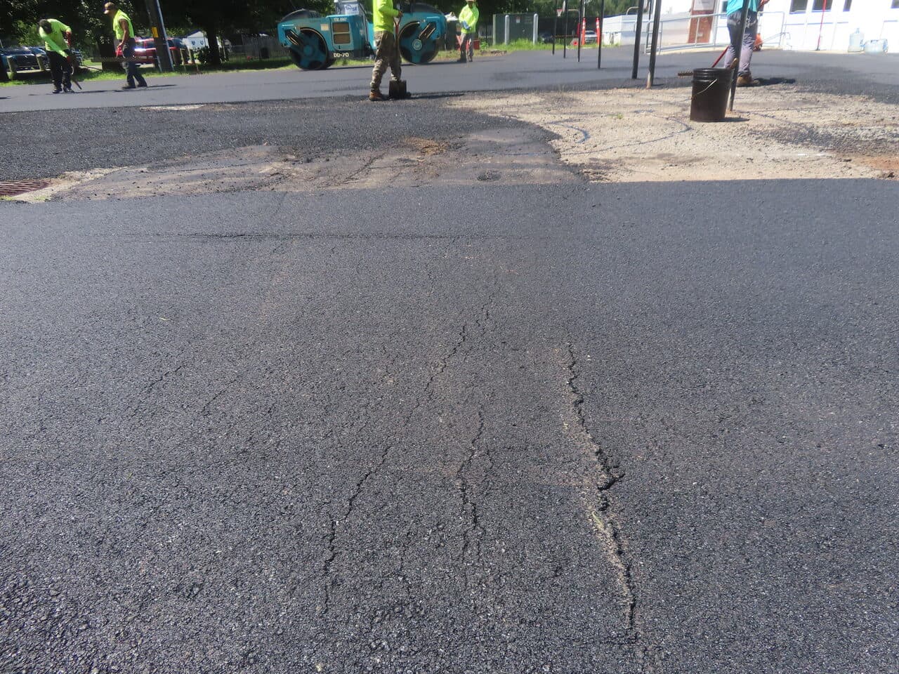 Commercial Parking Lot Paving project in Bloomfield, CT — cracked asphalt surface closeup