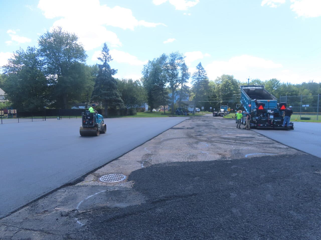 Commercial Parking Lot Paving project in Bloomfield, CT — roller and paver mid paving