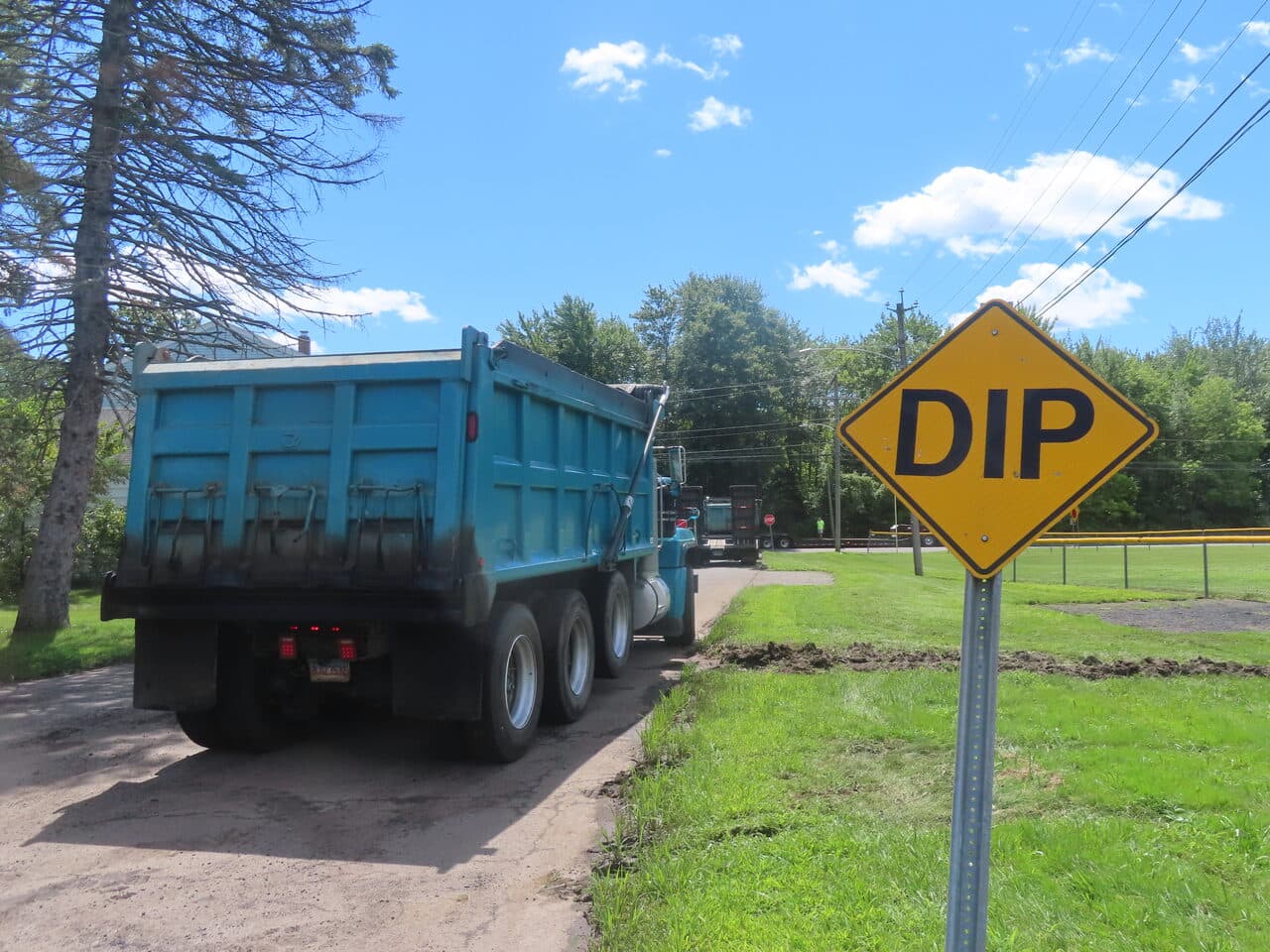 Commercial Parking Lot Paving project in Bloomfield, CT — dump truck passing DIP sign