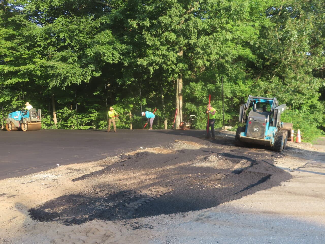 Commercial Parking Lot Paving project in Bloomfield, CT — skid steer grading lot in shade