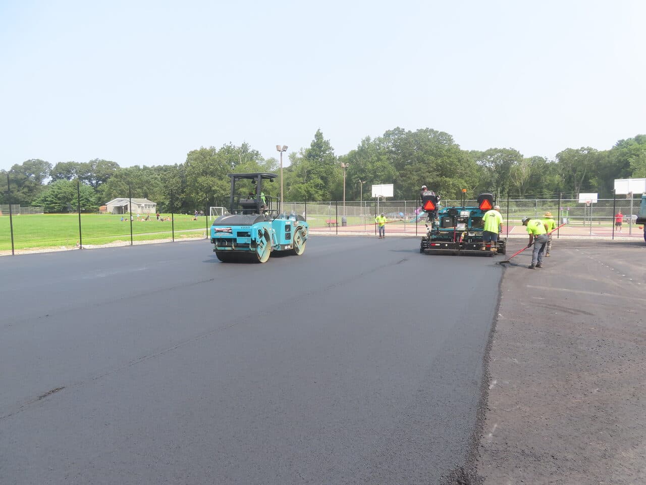 Commercial Parking Lot Paving project in Brooklyn, CT — asphalt paving with roller and paver