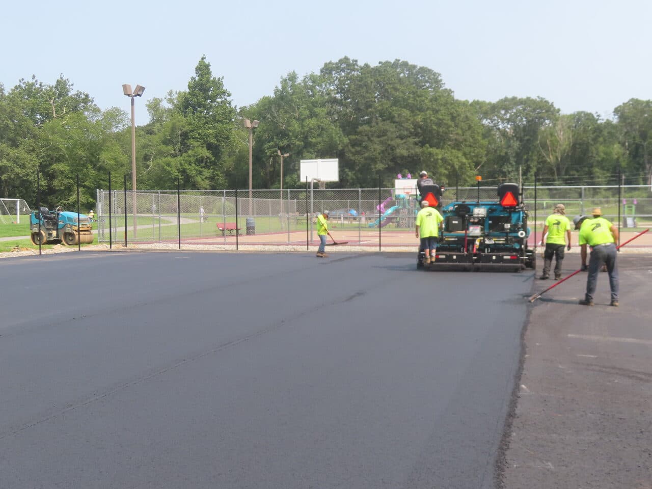 Commercial Parking Lot Paving project in Brooklyn, CT — paver laying asphalt by playground