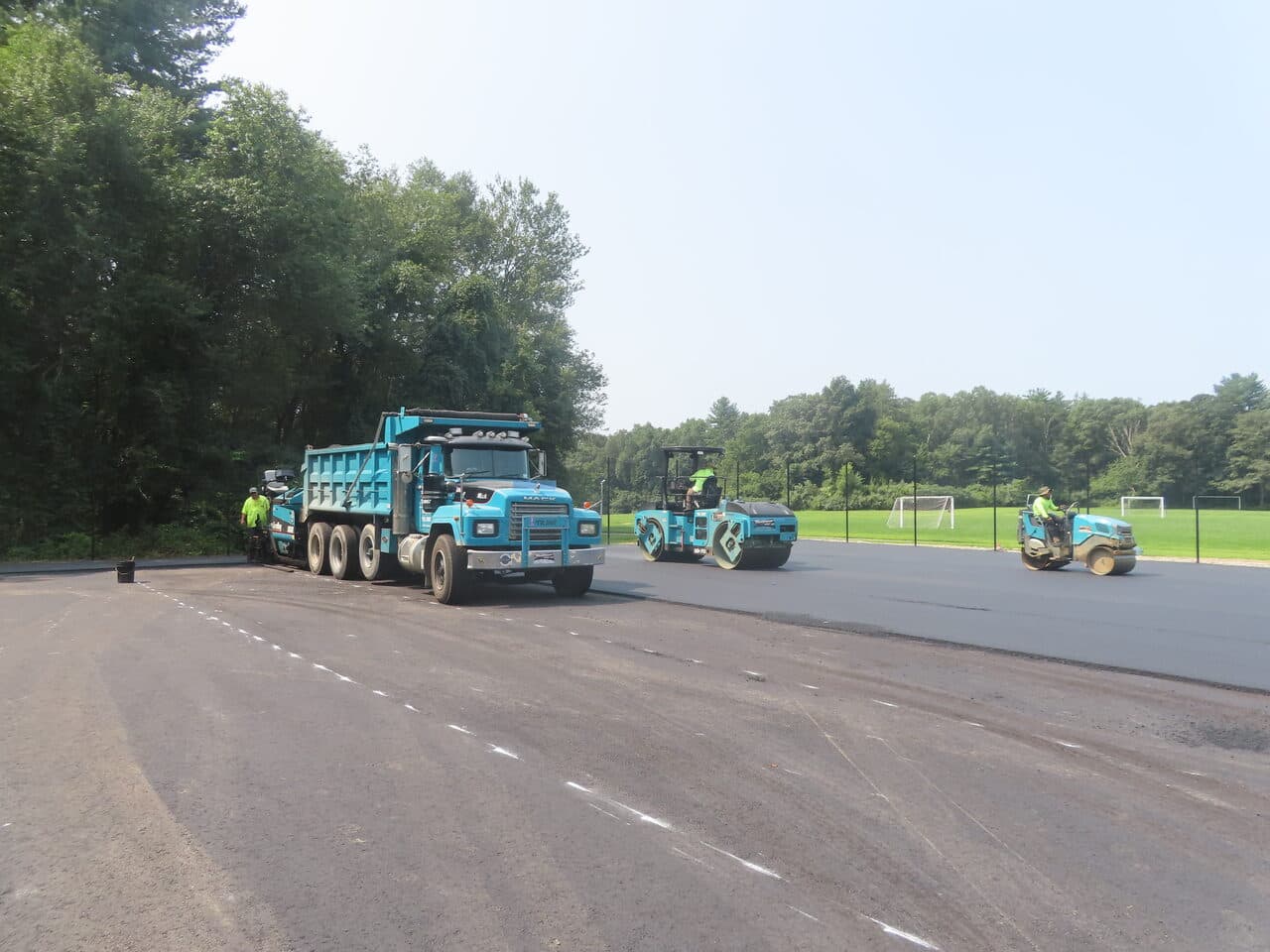 Commercial Parking Lot Paving project in Brooklyn, CT — dump truck and rollers compacting lot