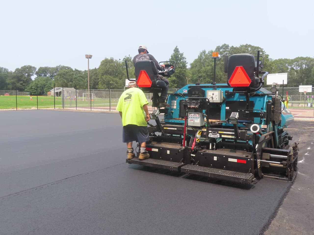 Commercial Parking Lot Paving project in Brooklyn, CT — asphalt paver rear close view