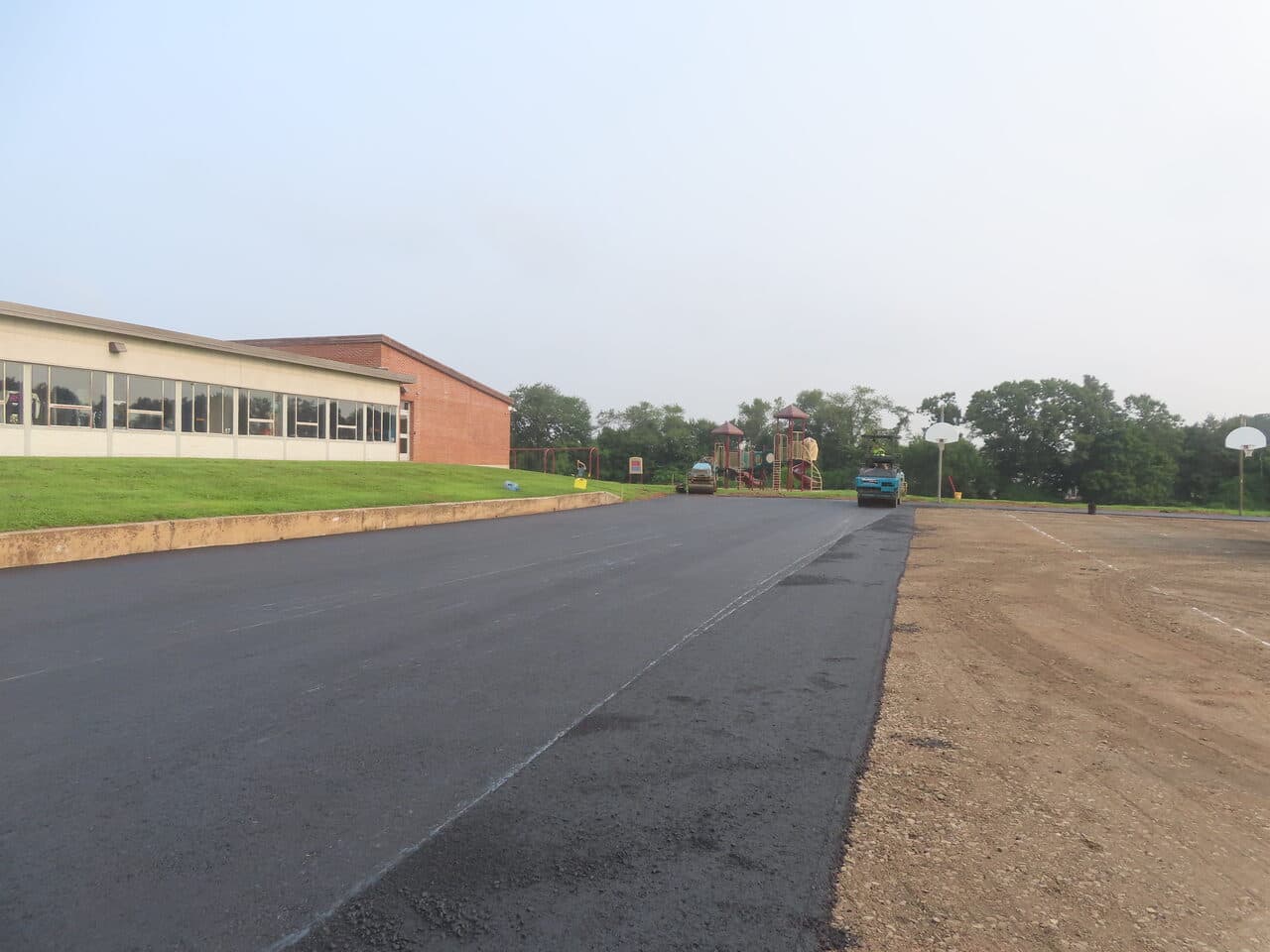 Commercial Parking Lot Paving project in Montowese, CT — fresh asphalt strip being laid