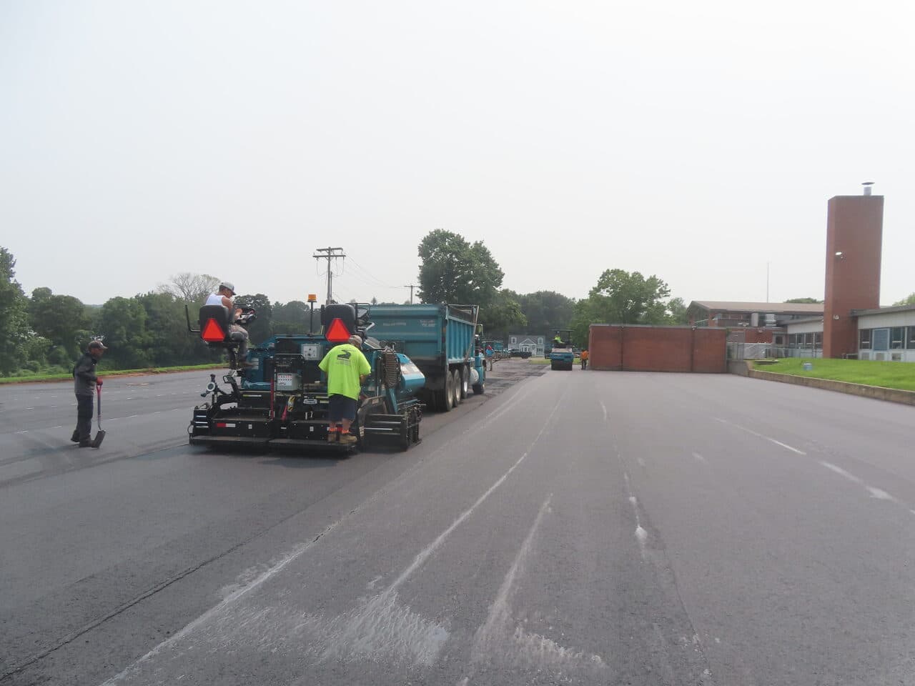 Commercial Parking Lot Paving project in Montowese, CT — paver and dump truck paving lot