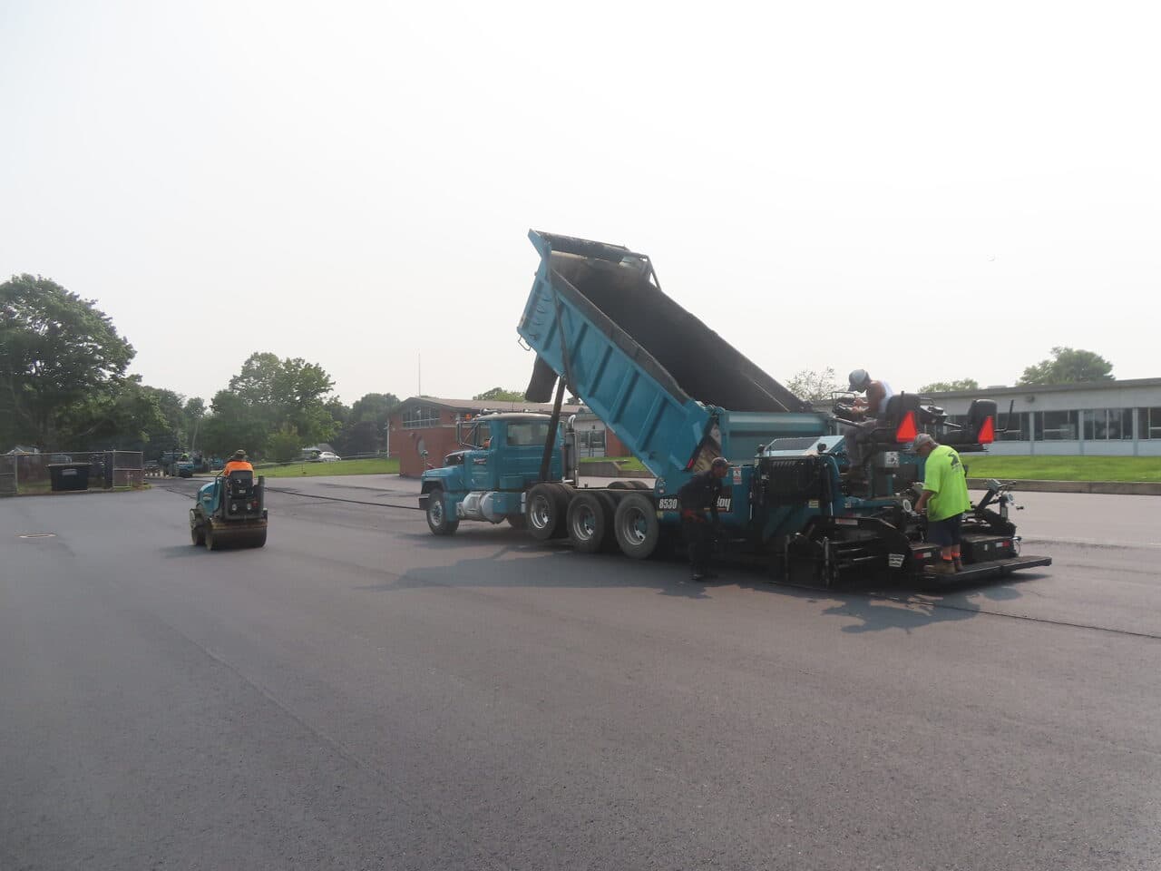 Commercial Parking Lot Paving project in Montowese, CT — dump truck loading paver roller