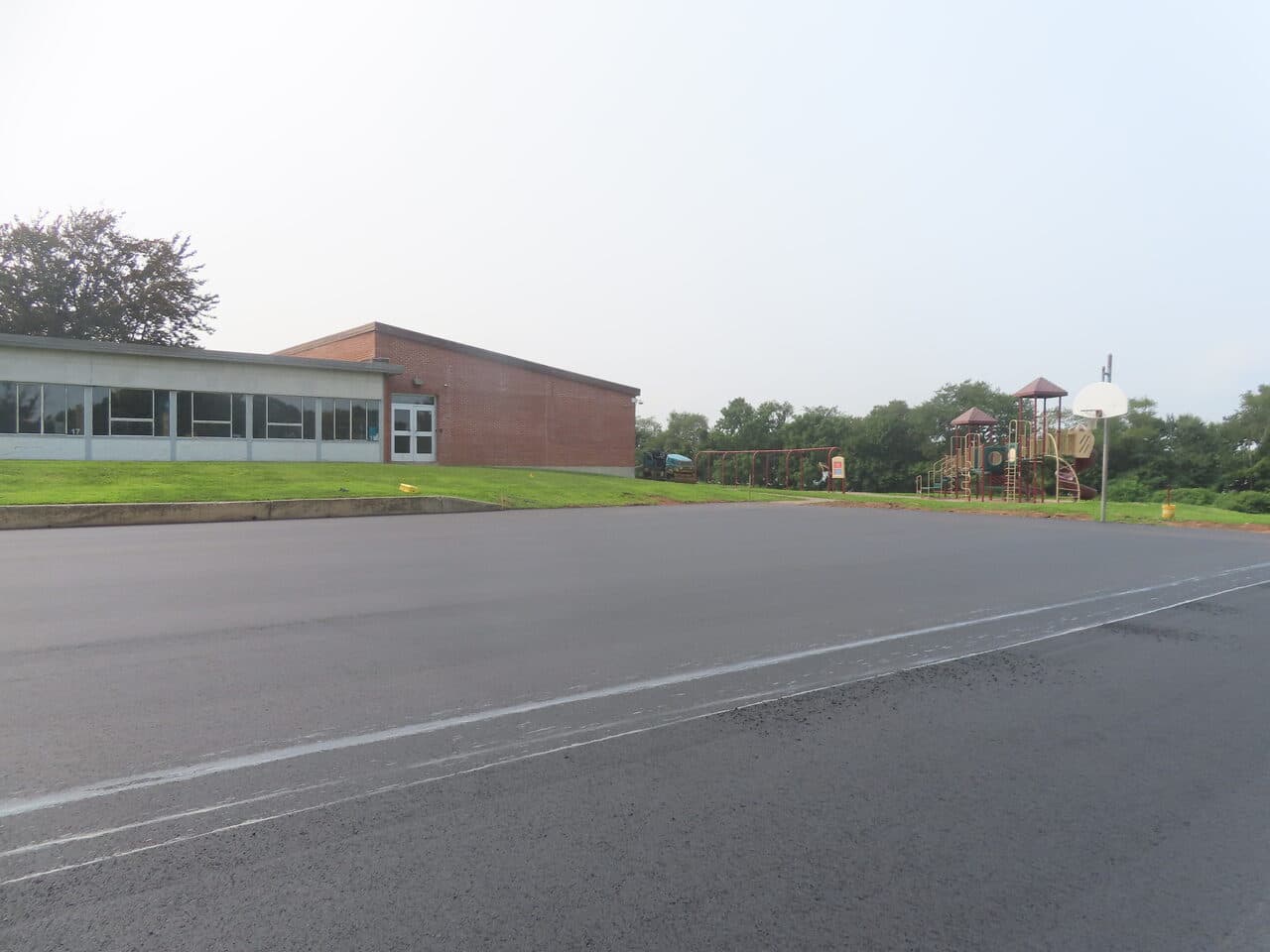 Commercial Parking Lot Paving project in Montowese, CT — finished asphalt lot by playground