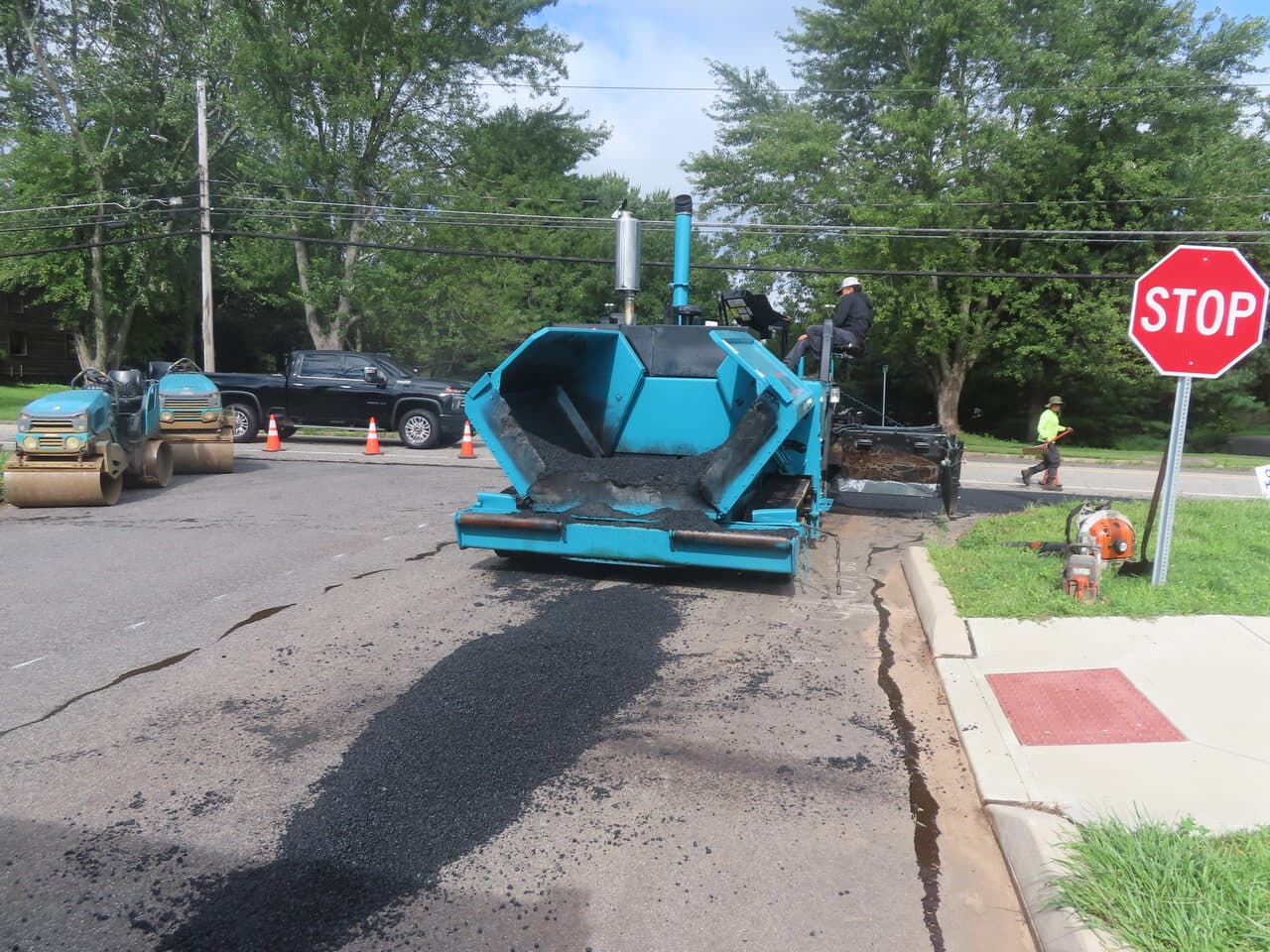 Roadway Paving project in Cheshire, CT — blue paver near stop sign