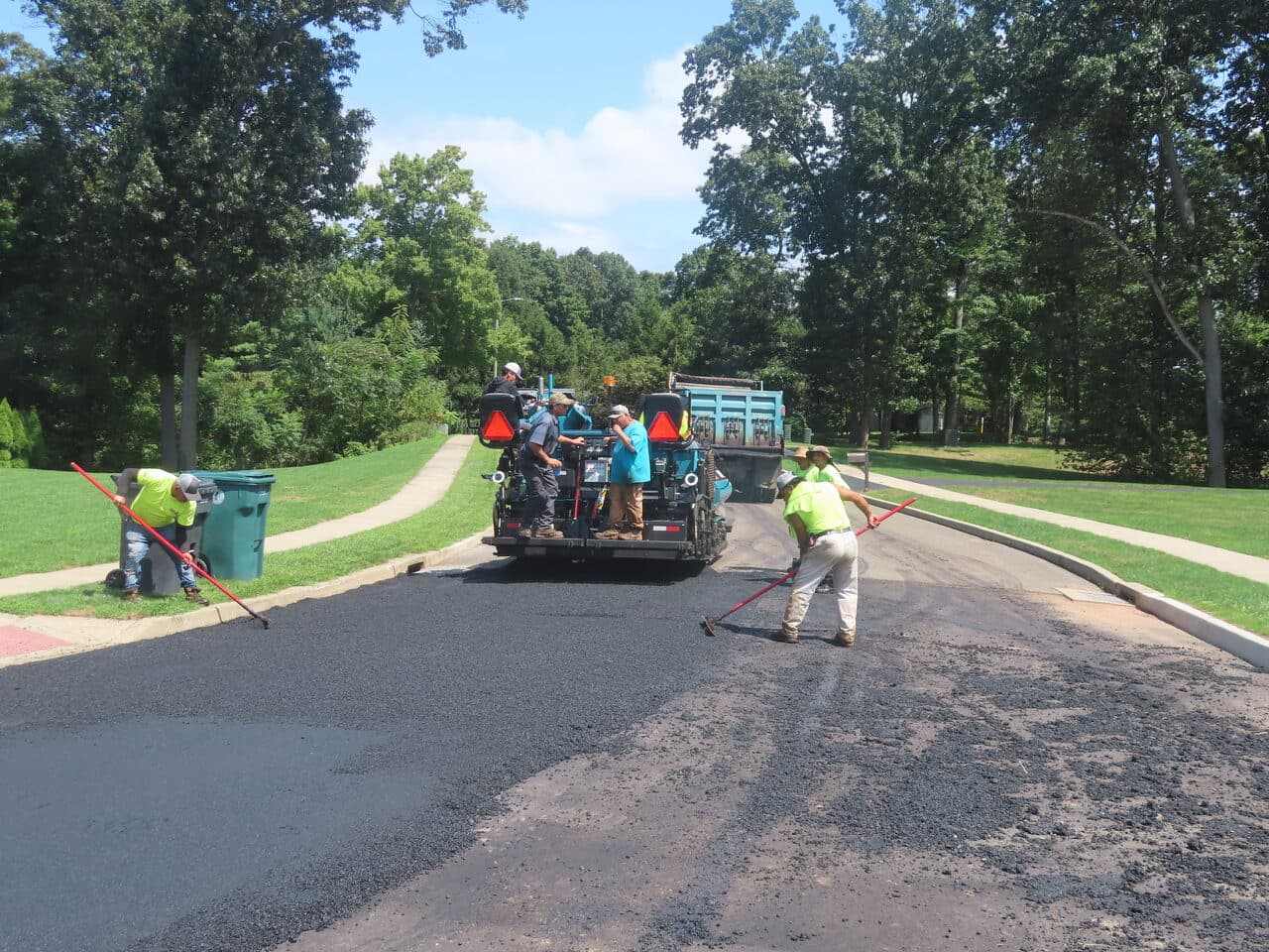 Before — Roadway Paving in Cheshire, CT (crew raking behind paver)