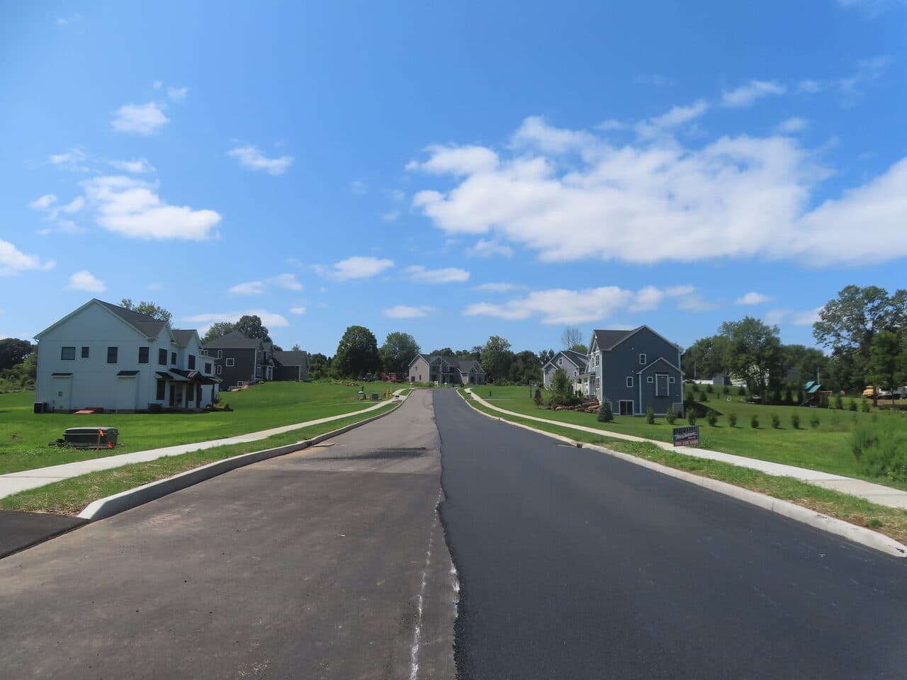 Roadway Paving project in Cheshire, CT — wide finished subdivision road