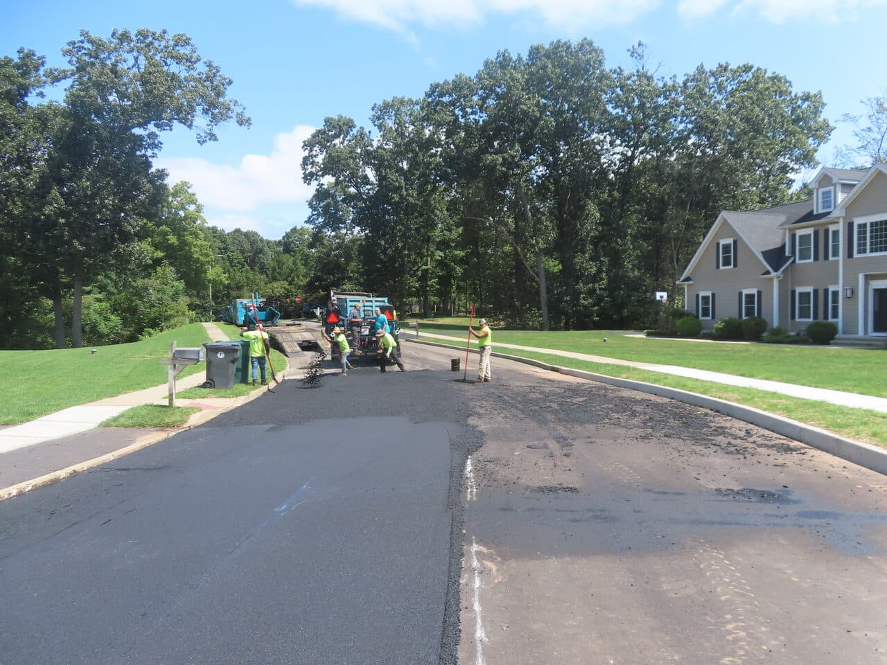 After — Roadway Paving in Cheshire, CT (crew raking behind paver)