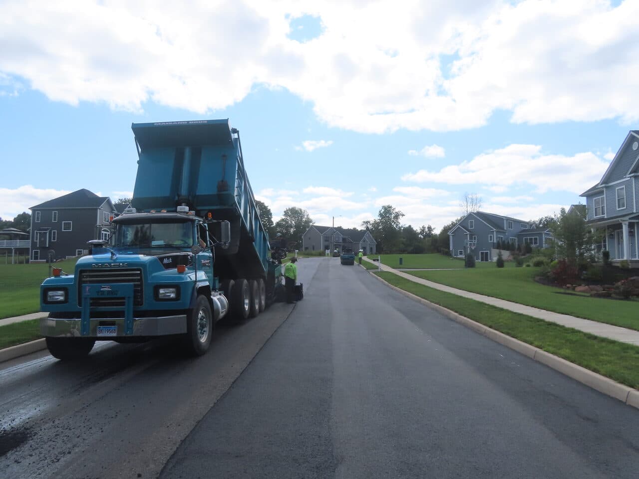 Roadway Paving project in Cheshire, CT — mack dump truck feeding paver