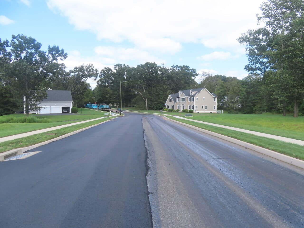 Roadway Paving project in Cheshire, CT — finished road two homes background