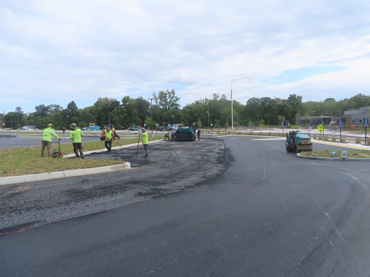 Commercial Parking Lot Paving project in Brookfield, CT — crew raking edges with roller