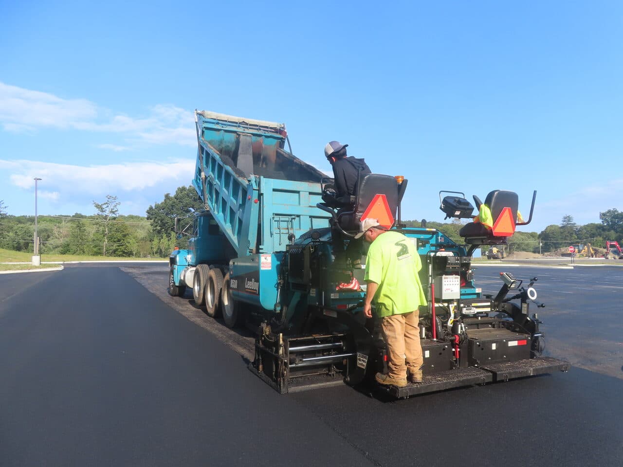Commercial Parking Lot Paving project in Brookfield, CT — leeboy paver and dump truck working