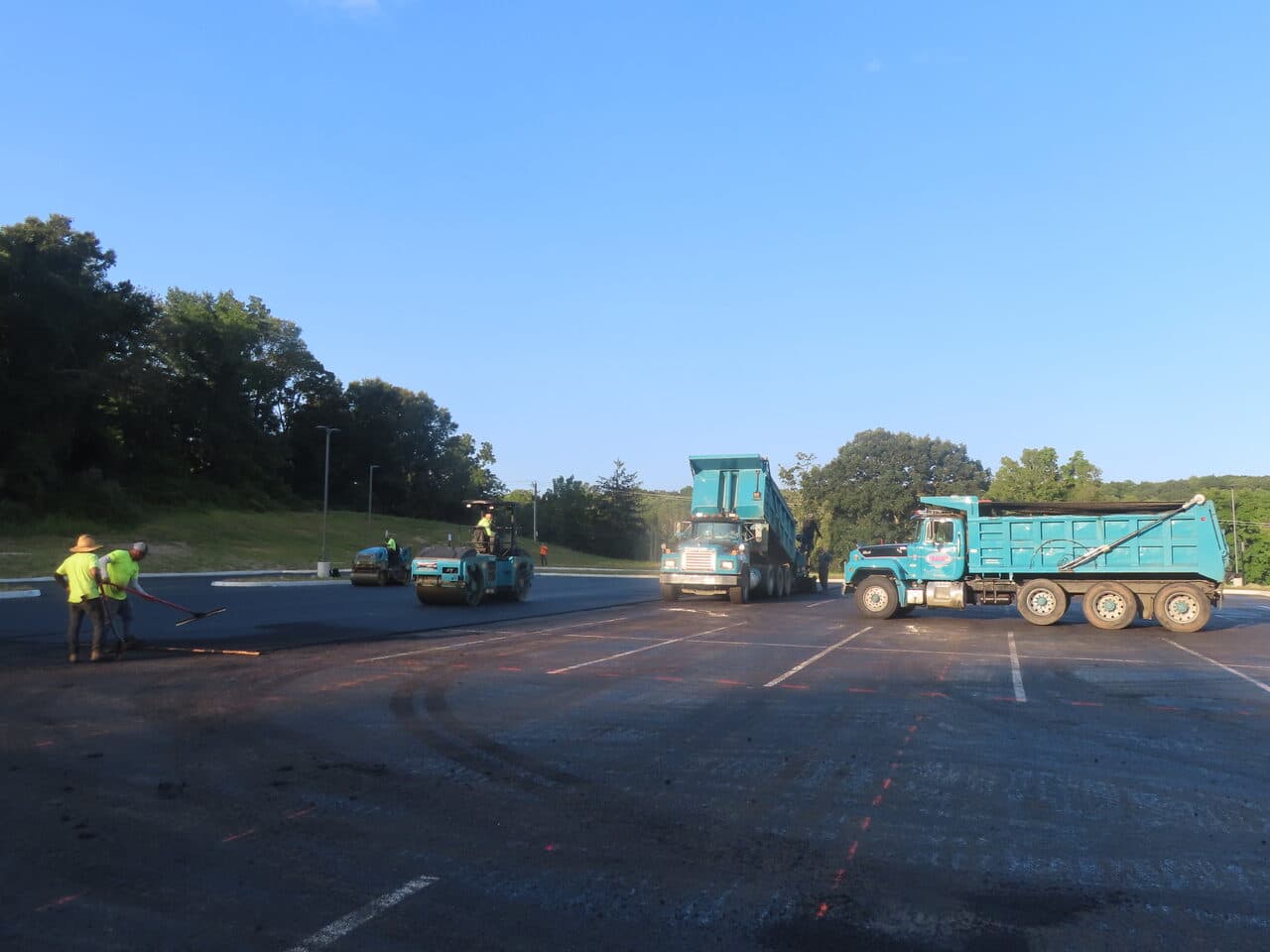 Commercial Parking Lot Paving project in Brookfield, CT — paving crew and two dump trucks