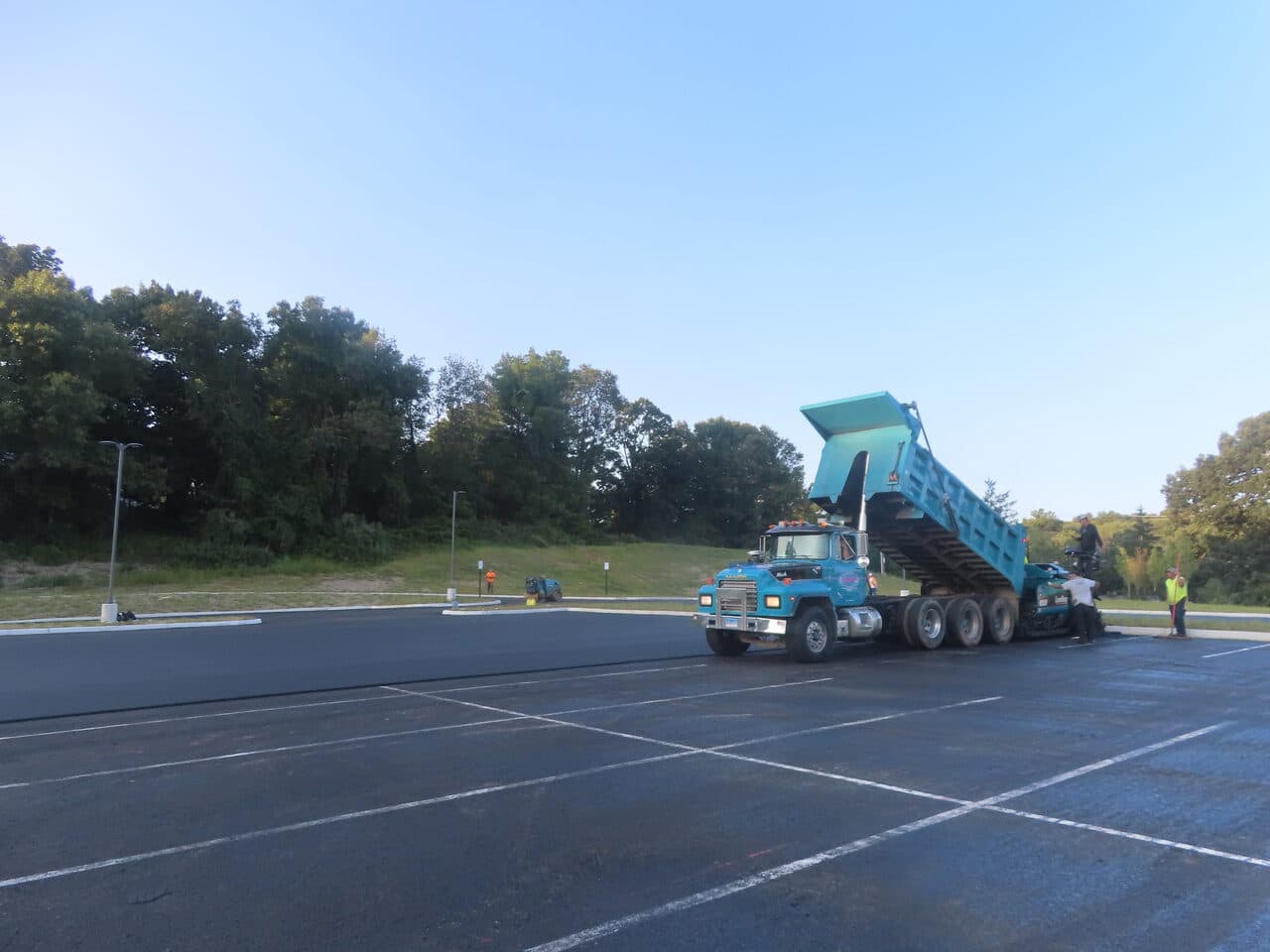 Commercial Parking Lot Paving project in Brookfield, CT — dump truck dumping into paver