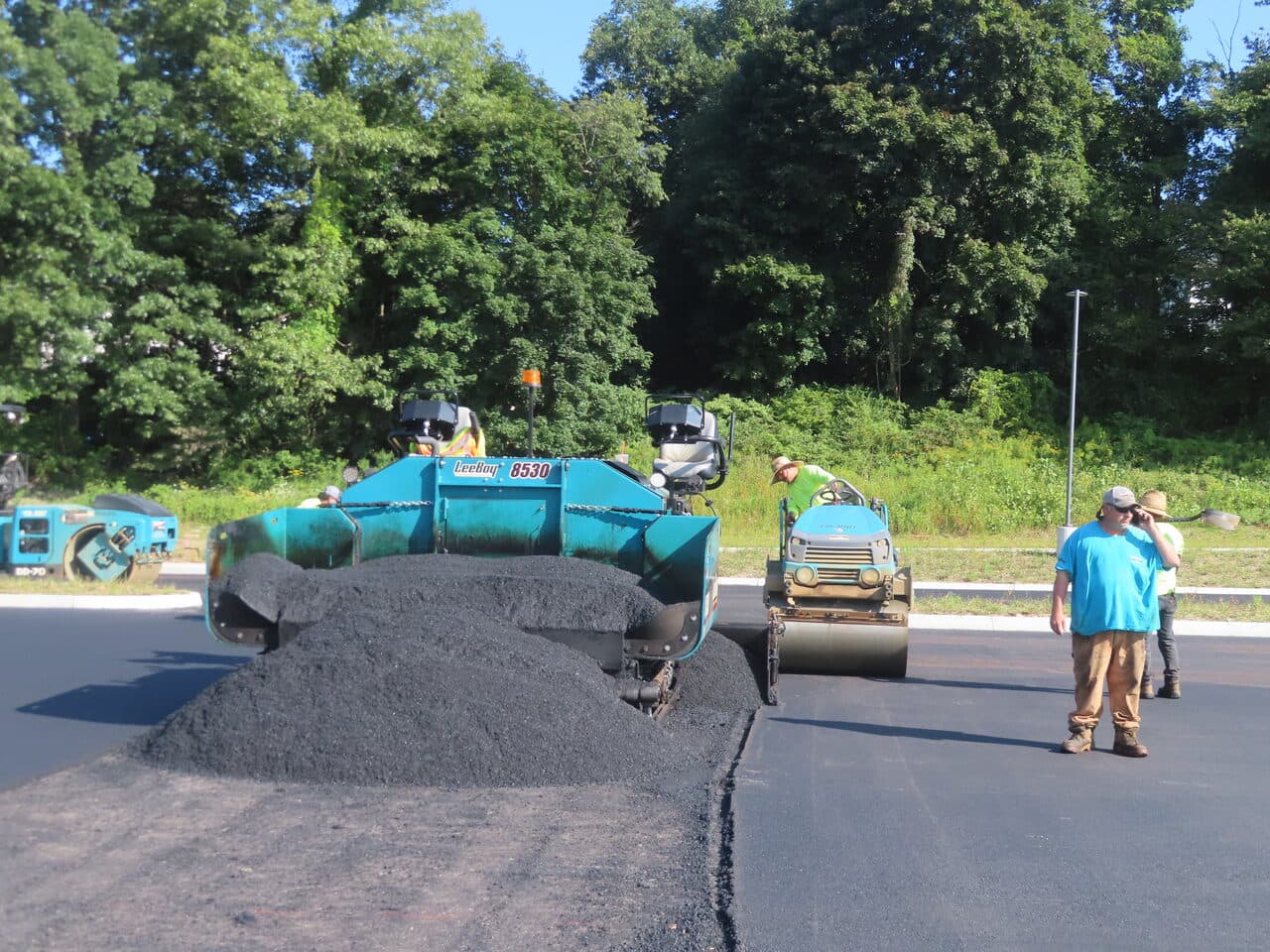 Commercial Parking Lot Paving project in Brookfield, CT — asphalt pile in paver hopper