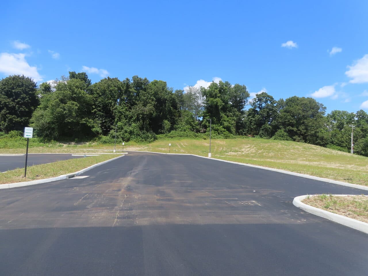 Commercial Parking Lot Paving project in Brookfield, CT — fresh paved lot entrance and curbs