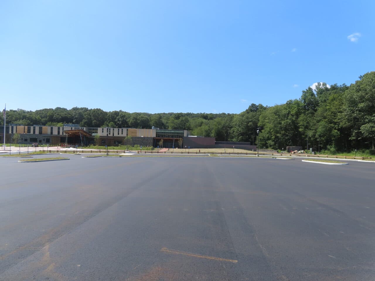 Commercial Parking Lot Paving project in Brookfield, CT — wide finished lot building backdrop