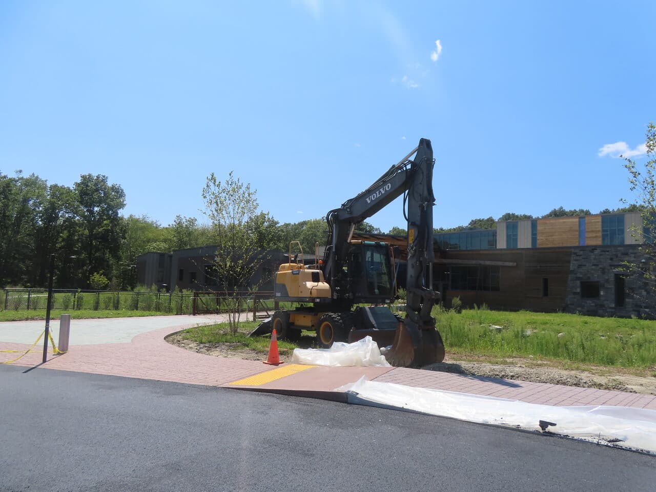 Commercial Parking Lot Paving project in Brookfield, CT — volvo excavator parked by building
