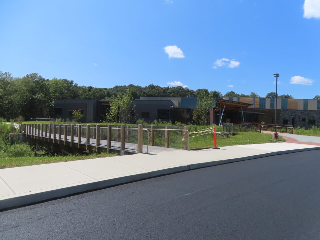 Commercial Parking Lot Paving project in Brookfield, CT — boardwalk and sidewalk by building