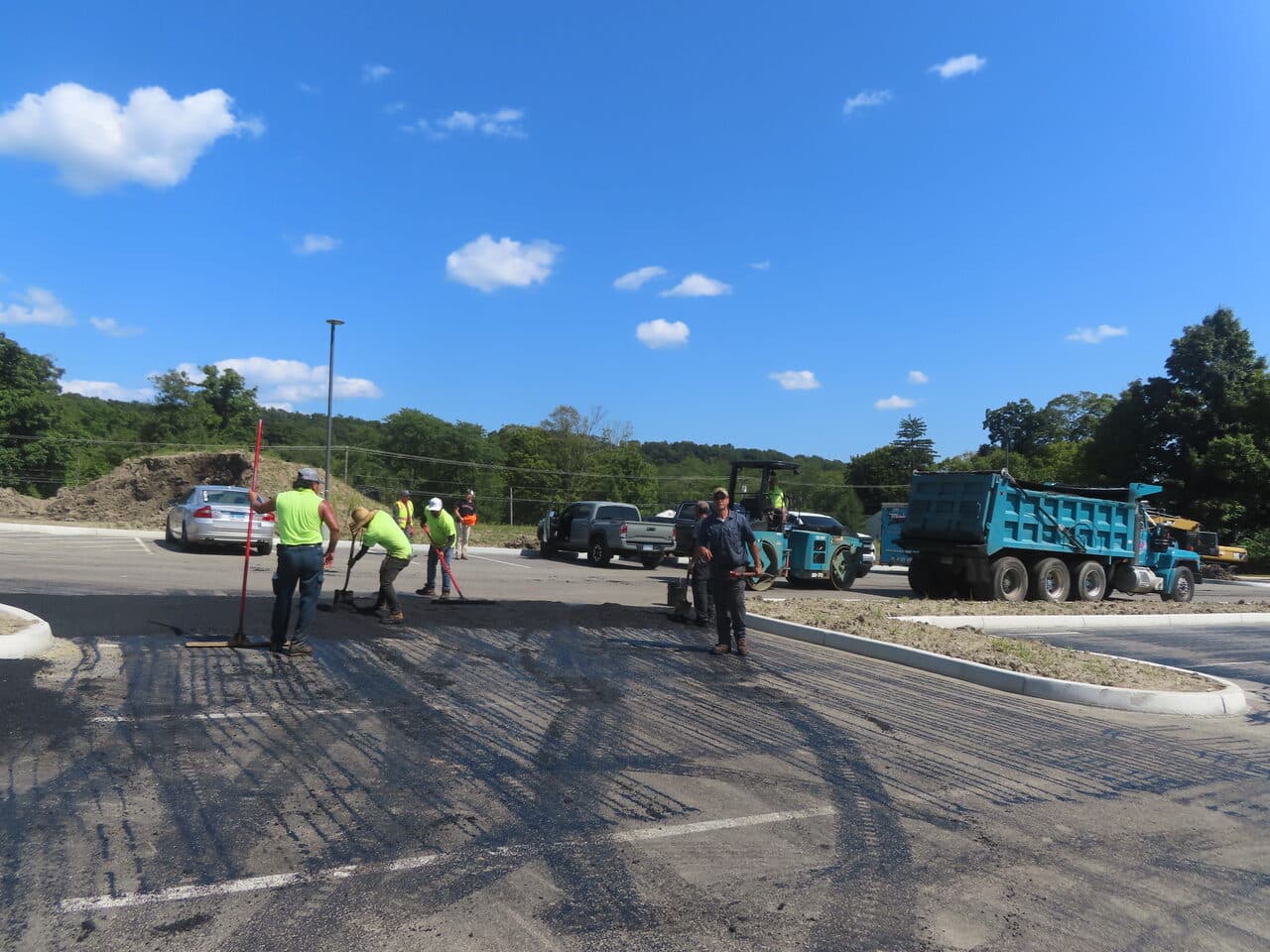 Commercial Parking Lot Paving project in Brookfield, CT — crew raking and grading lot