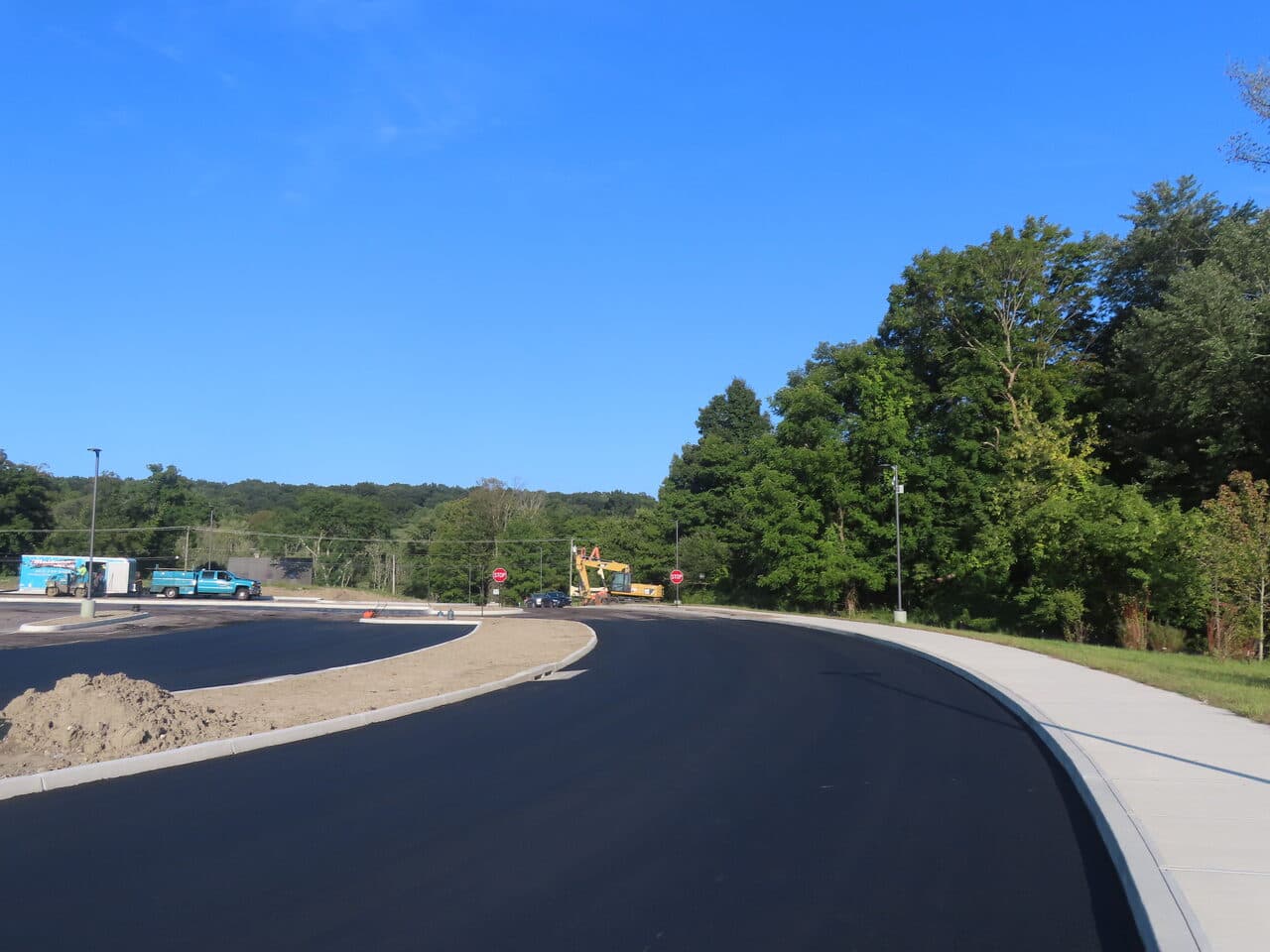 Commercial Parking Lot Paving project in Brookfield, CT — fresh black access road with curb