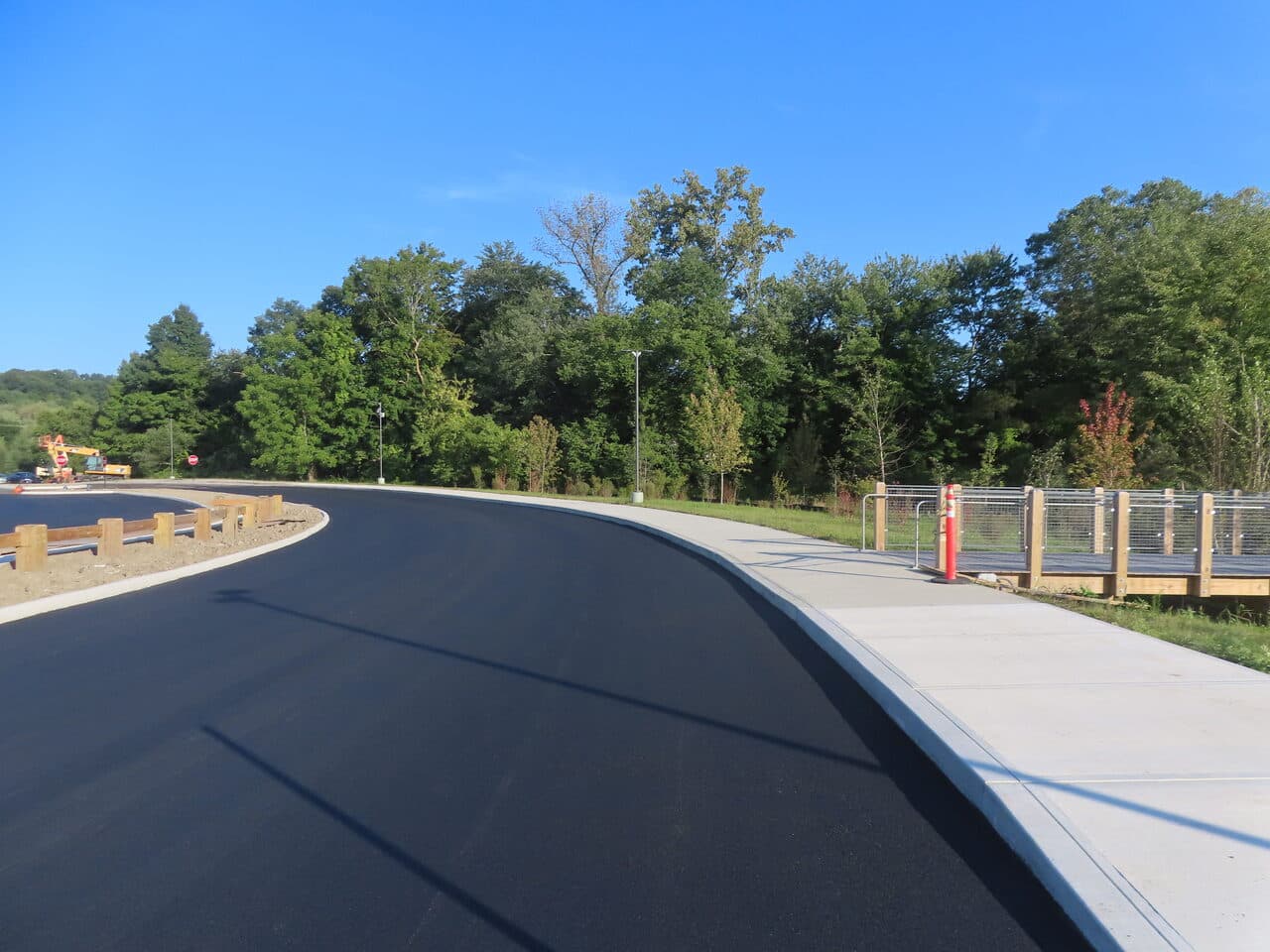 Commercial Parking Lot Paving project in Brookfield, CT — finished curving road by sidewalk