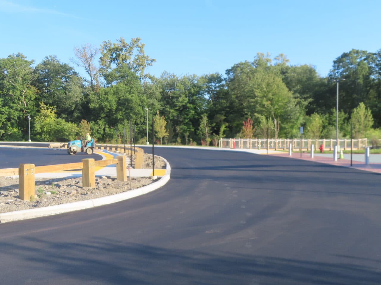 Commercial Parking Lot Paving project in Brookfield, CT — finished drive with timber guardrail
