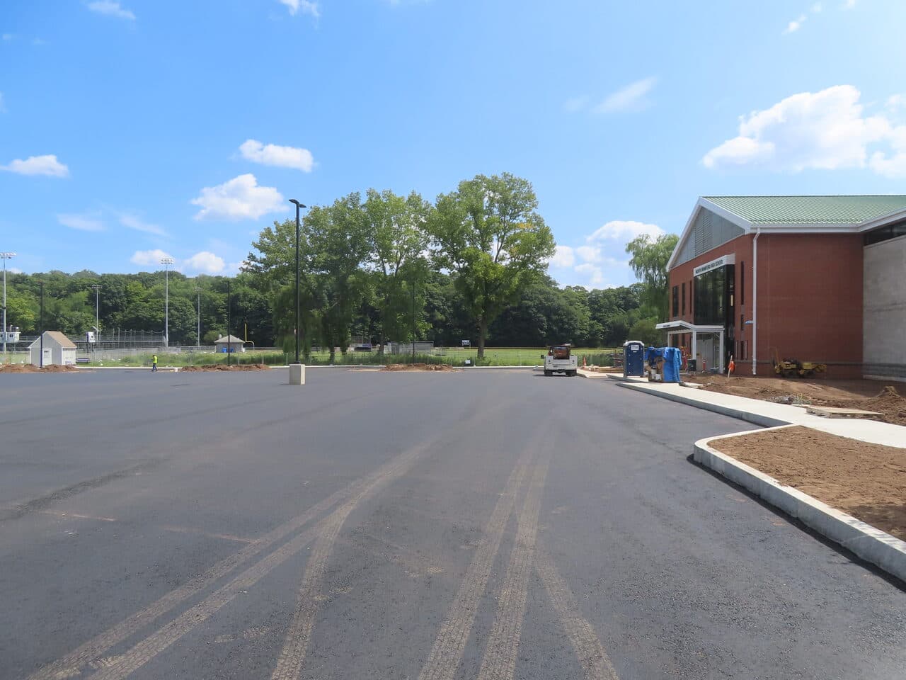 Commercial Parking Lot Paving project in North Branford, CT — wide new parking lot beside school
