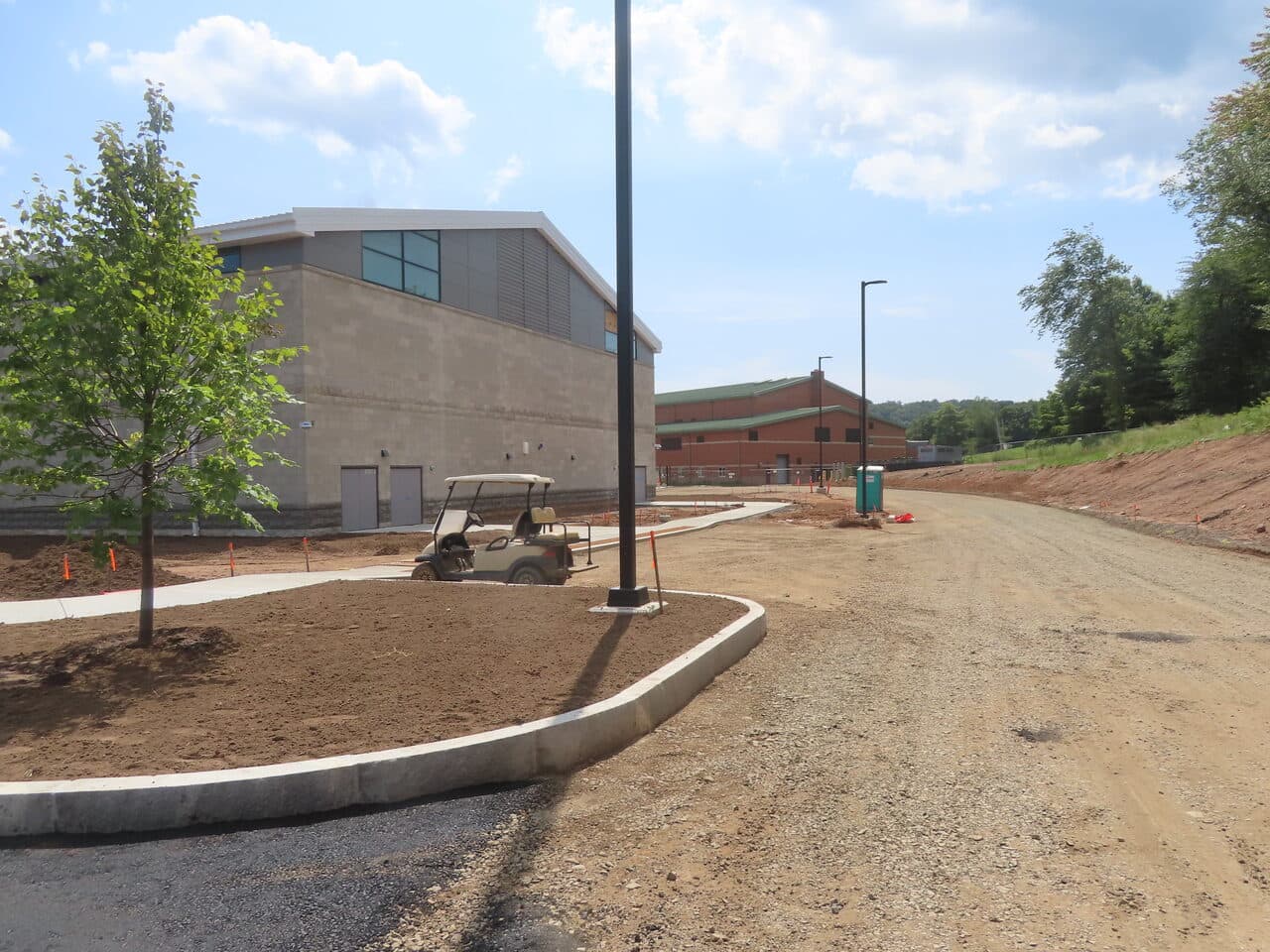 Commercial Parking Lot Paving project in North Branford, CT — curbed walkway and golf cart by gym