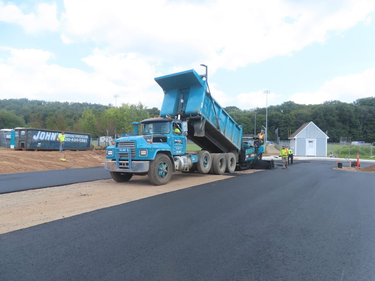 Commercial Parking Lot Paving project in North Branford, CT — dump truck and paver laying asphalt