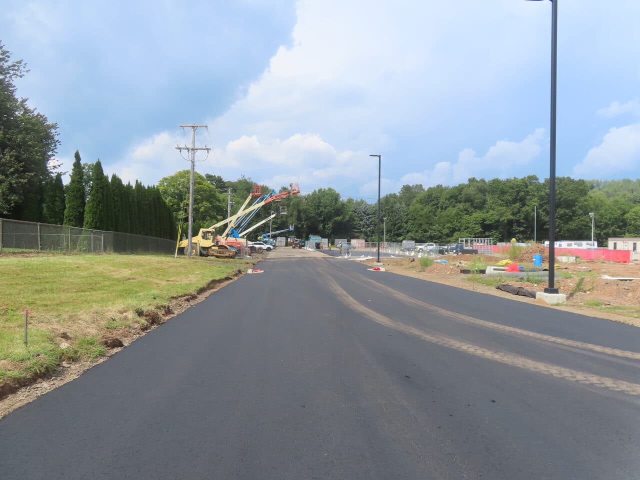 Commercial Parking Lot Paving project in North Branford, CT — fresh paved roadway with equipment