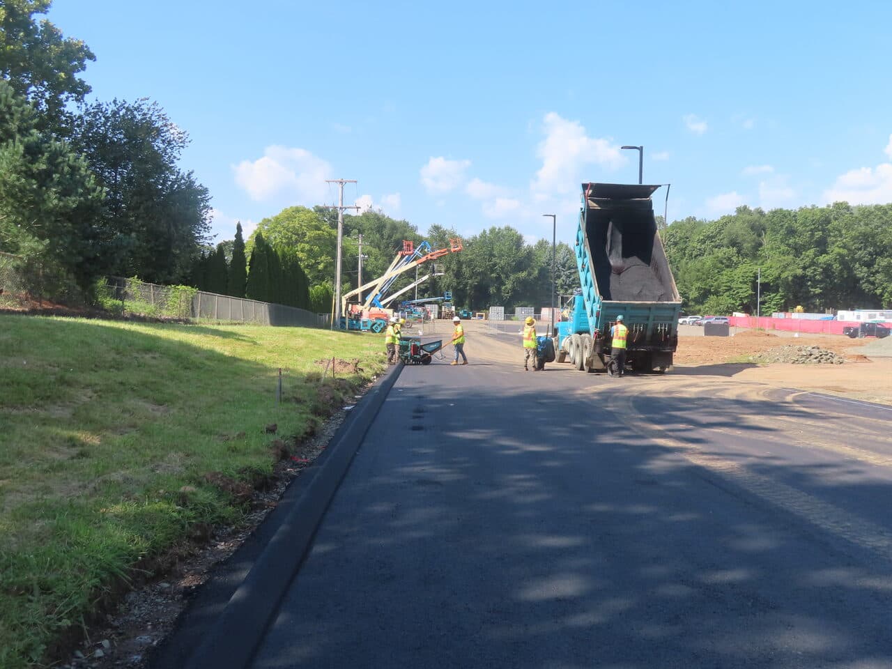 Commercial Parking Lot Paving project in North Branford, CT — crew laying asphalt with dump truck