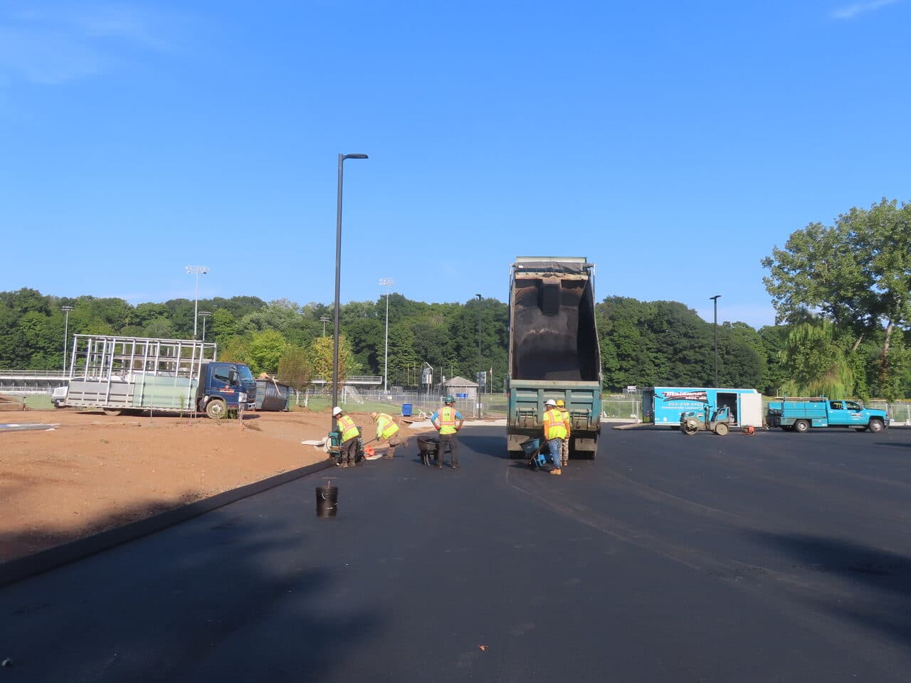 Commercial Parking Lot Paving project in North Branford, CT — crew paving lot with dump truck