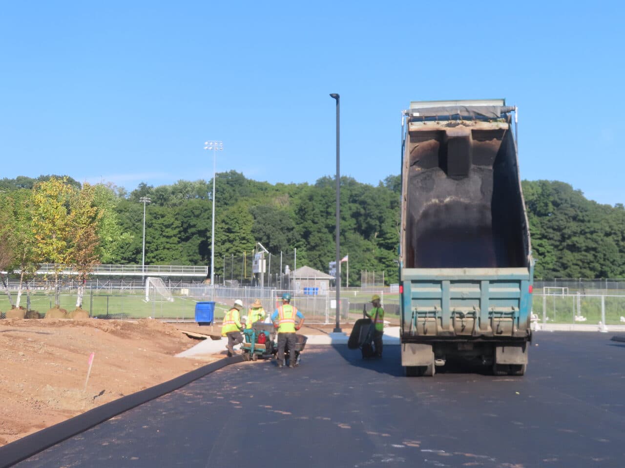 Commercial Parking Lot Paving project in North Branford, CT — crew spreading asphalt by dump truck