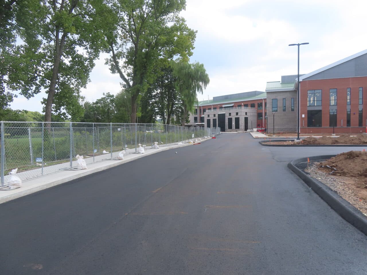 Commercial Parking Lot Paving project in North Branford, CT — fresh asphalt access drive at commercial building
