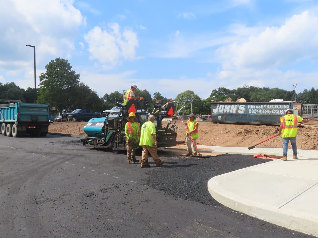 Commercial Parking Lot Paving project in North Branford, CT — paving crew laying asphalt with paver
