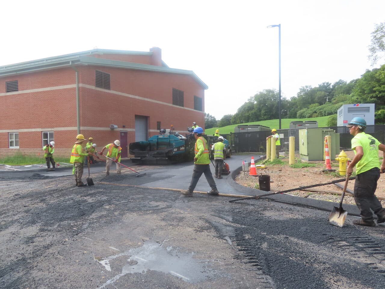 Commercial Parking Lot Paving project in North Branford, CT — crew paving area behind building