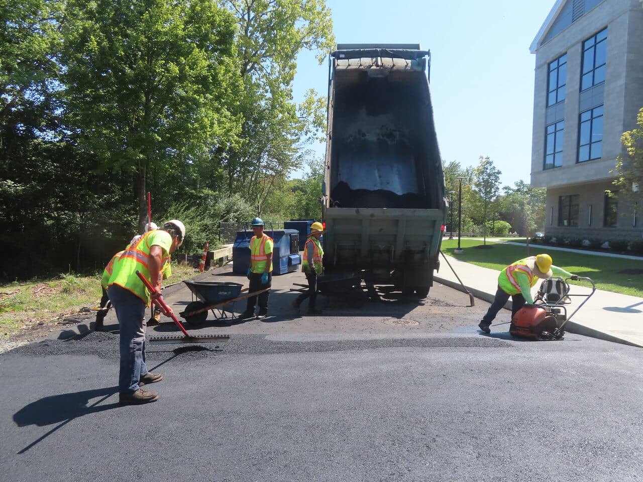 Commercial Parking Lot Paving project in North Branford, CT — crew laying asphalt at commercial building