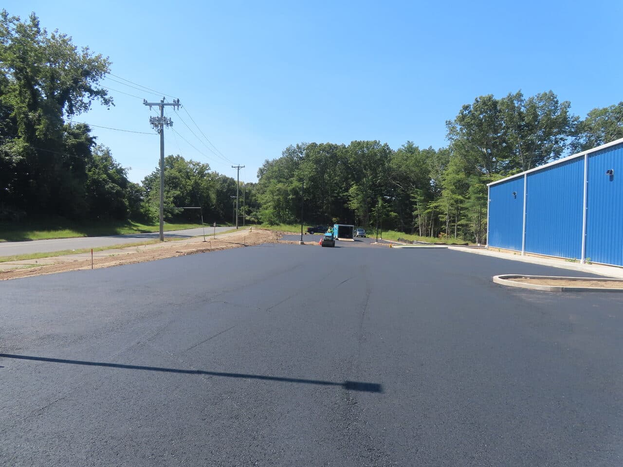 Commercial Parking Lot Paving project in Plainville, CT — wide finished asphalt lot by building