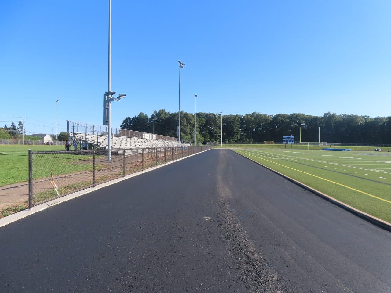Athletic Surface Base Paving project in Southington, CT — finished asphalt track straightaway