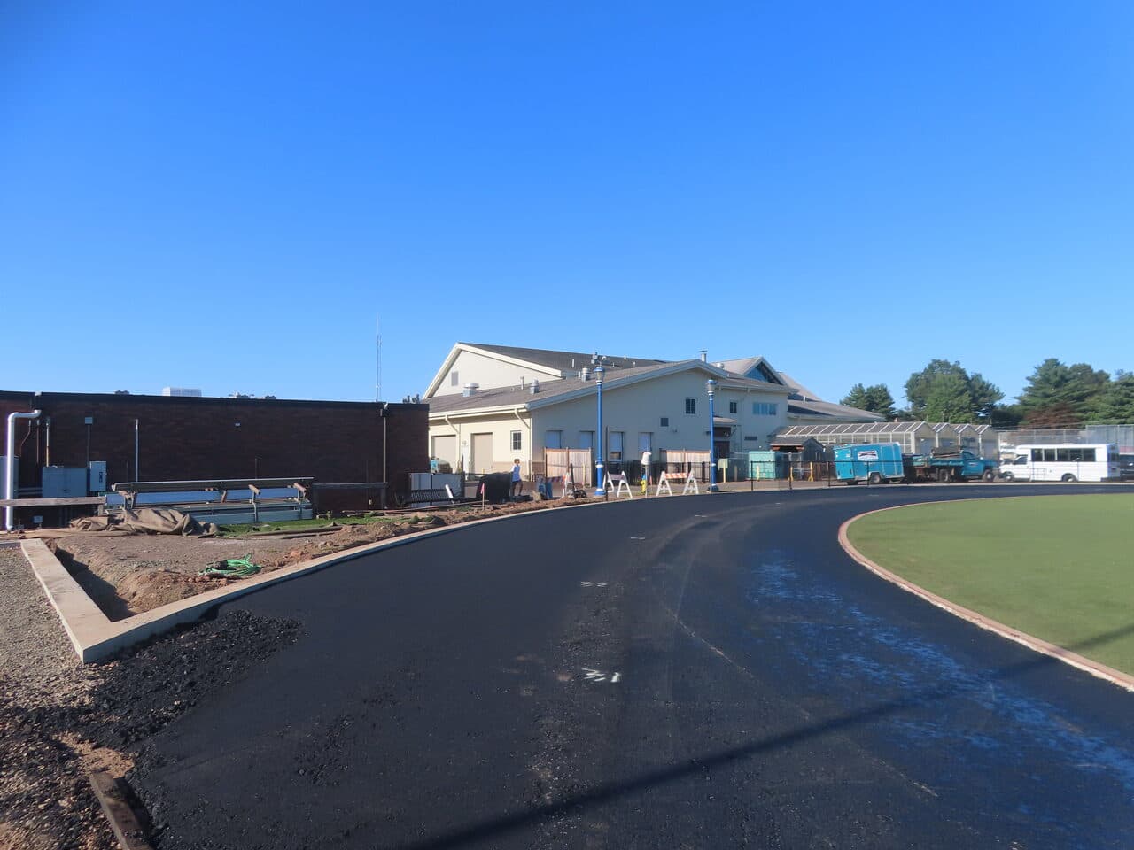 Athletic Surface Base Paving project in Southington, CT — fresh paved track near field house