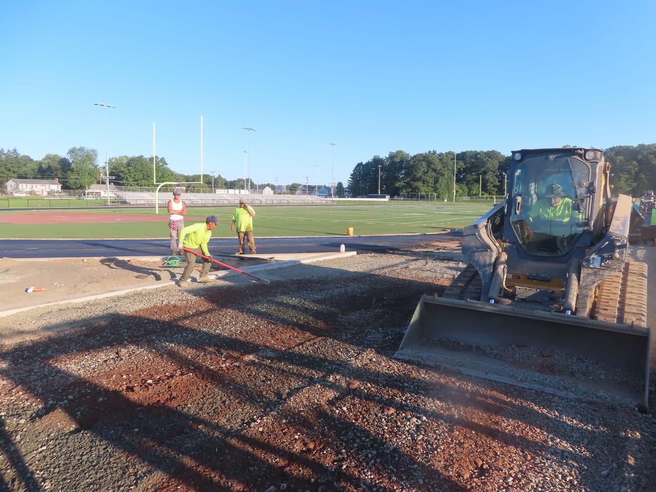 Athletic Surface Base Paving project in Southington, CT — skid steer grading track base