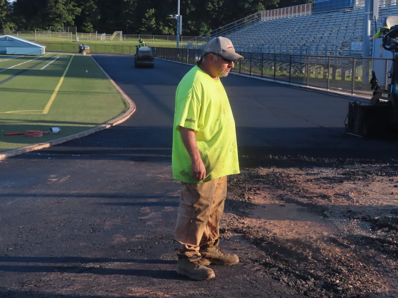 Athletic Surface Base Paving project in Southington, CT — skid steer grading stone base