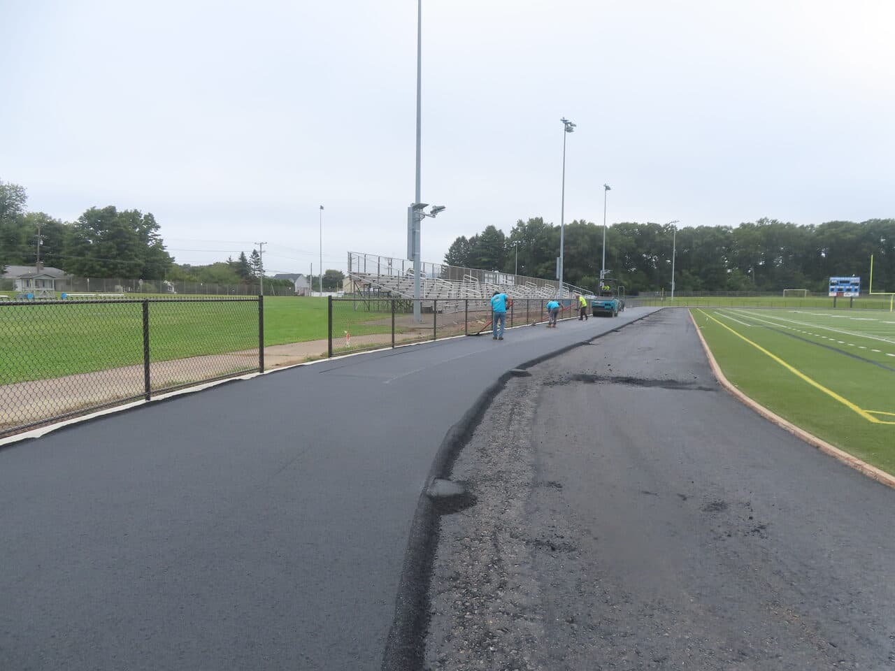 Athletic Surface Base Paving project in Southington, CT — fresh asphalt track section